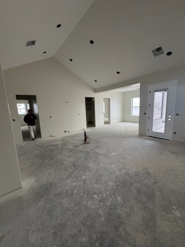 Large vaulted ceiling room with finished drywall
