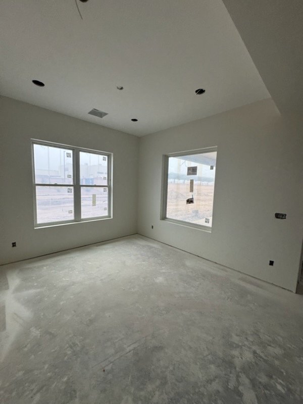 Finished drywall room with windows
