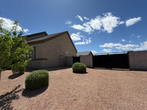 Stucco home with gated side yard