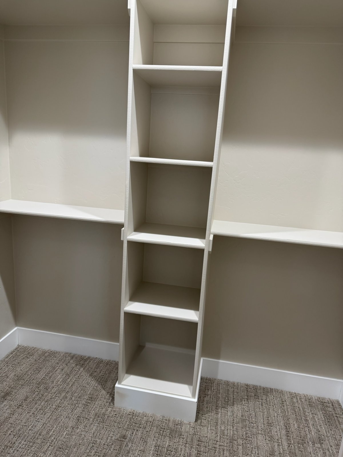 White painted closet with built-in shelving